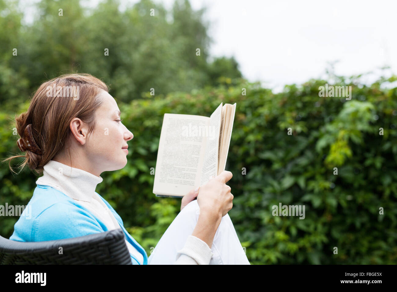Young woman reading a book Stock Photo