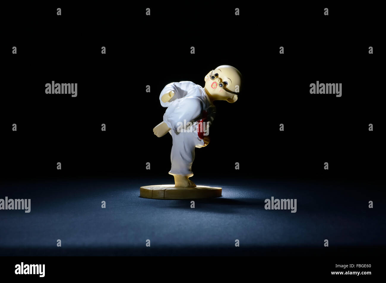 Model Karate Fighter in Fighting Stance on Black Background Stock Photo