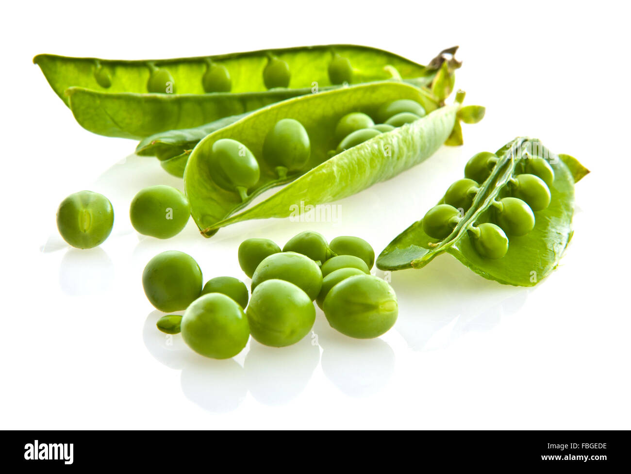 Fresh green pea pods and peas on white background. Stock Photo