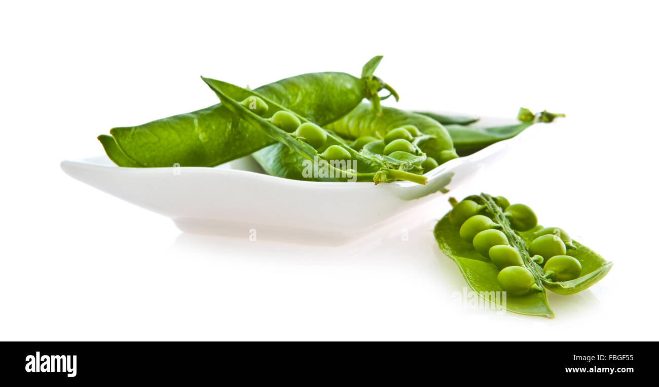 Fresh pea and pod in a dish isolated on white background Stock Photo