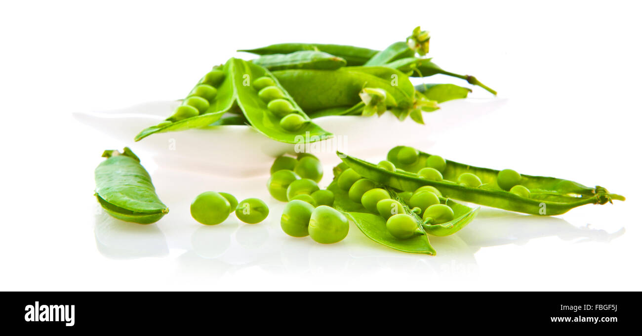 Fresh peas and pods in a dish isolated on white background Stock Photo