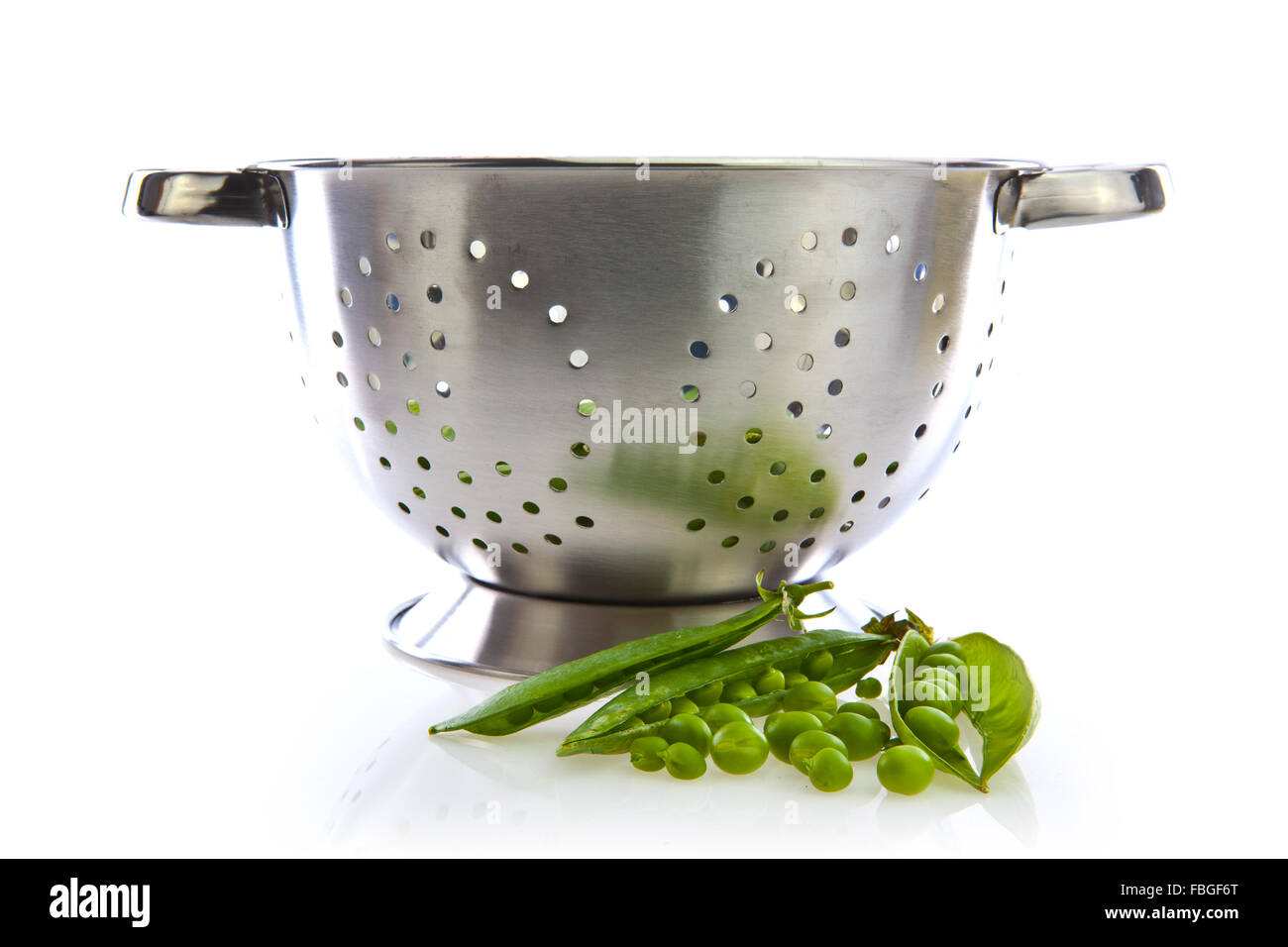 Freshly picked home grown organic peas in a colander Stock Photo