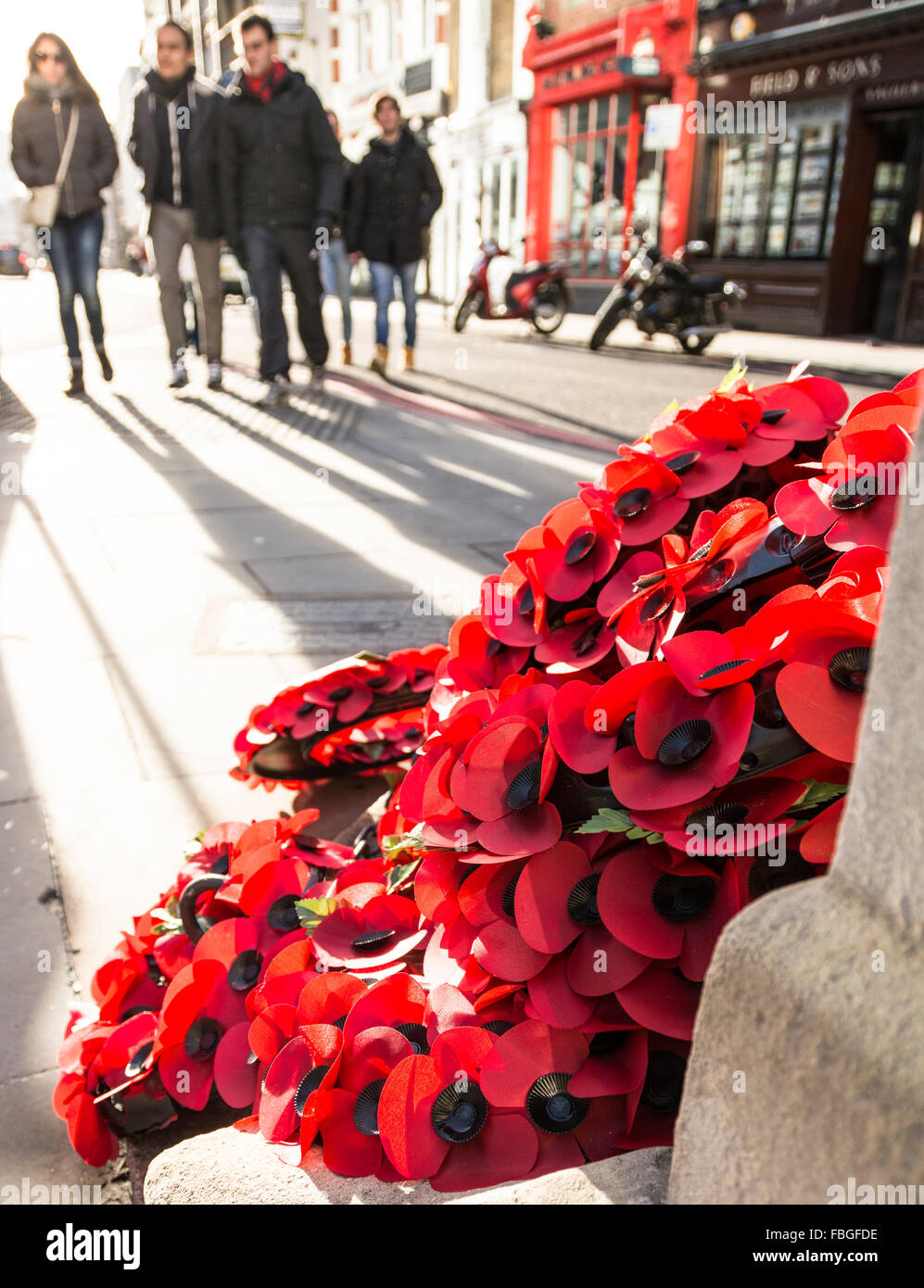 A wreath of red poppies laying in a London street commemorates the ...