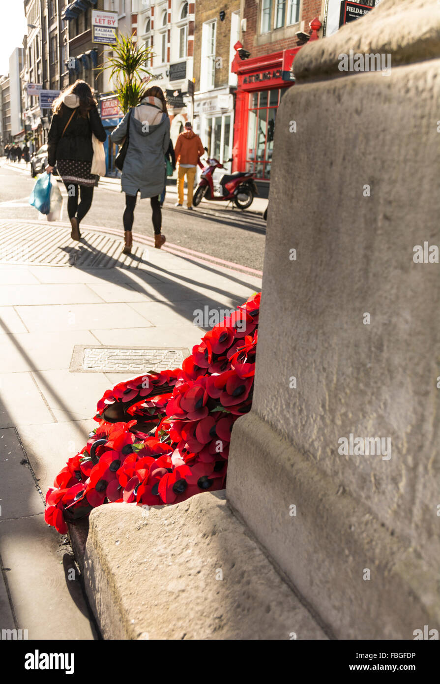 A wreath of red poppies laying in a London street commemorates the ...