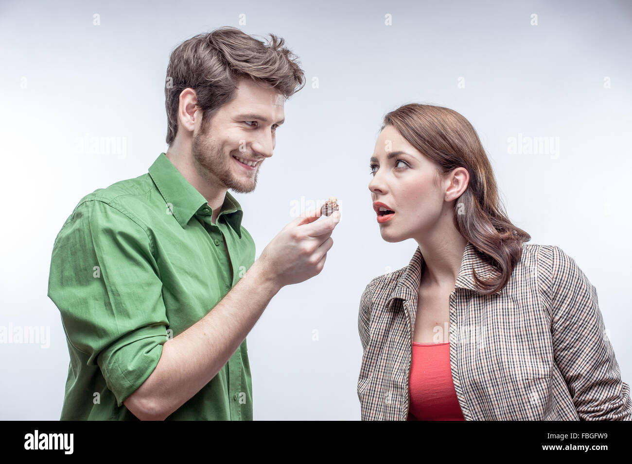 Young couple in love teasing each other with a chocolate Stock Photo