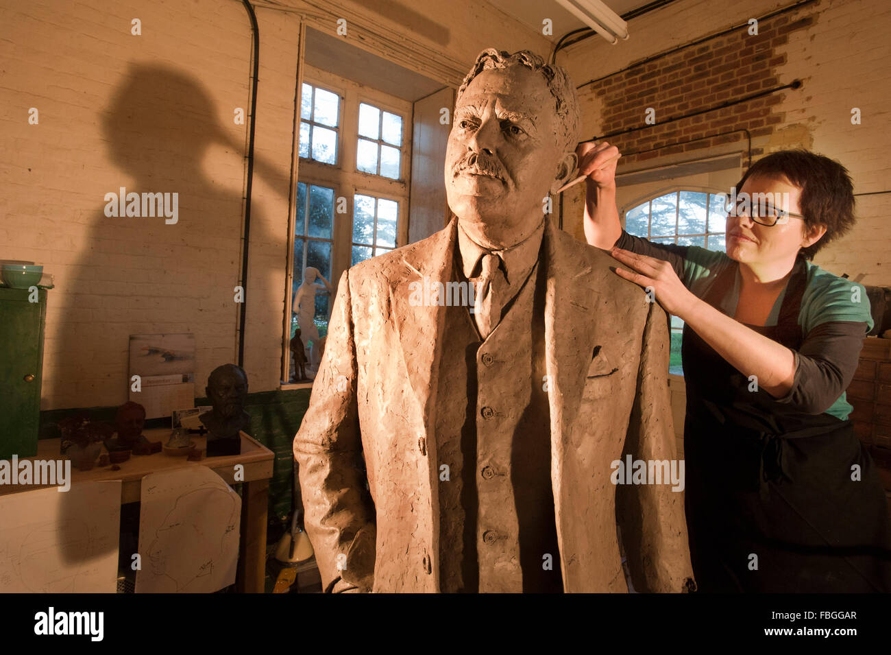 Sculptor Hazel Reeves works on the statue of Sir Nigel Gresley, the designer of the Flying Scotsman, for Kings Cross Station. Stock Photo