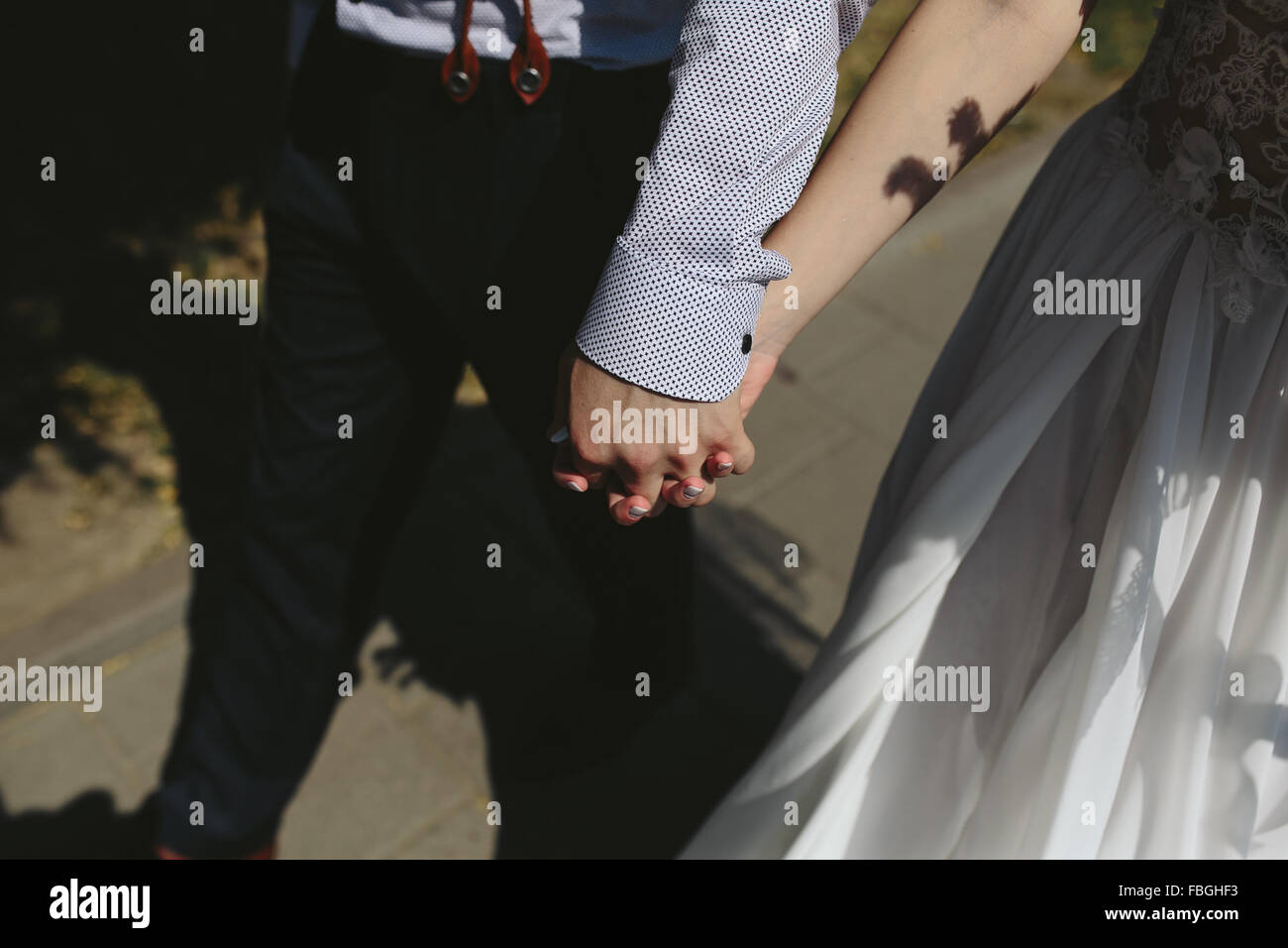 bride and groom walking around the city Stock Photo - Alamy