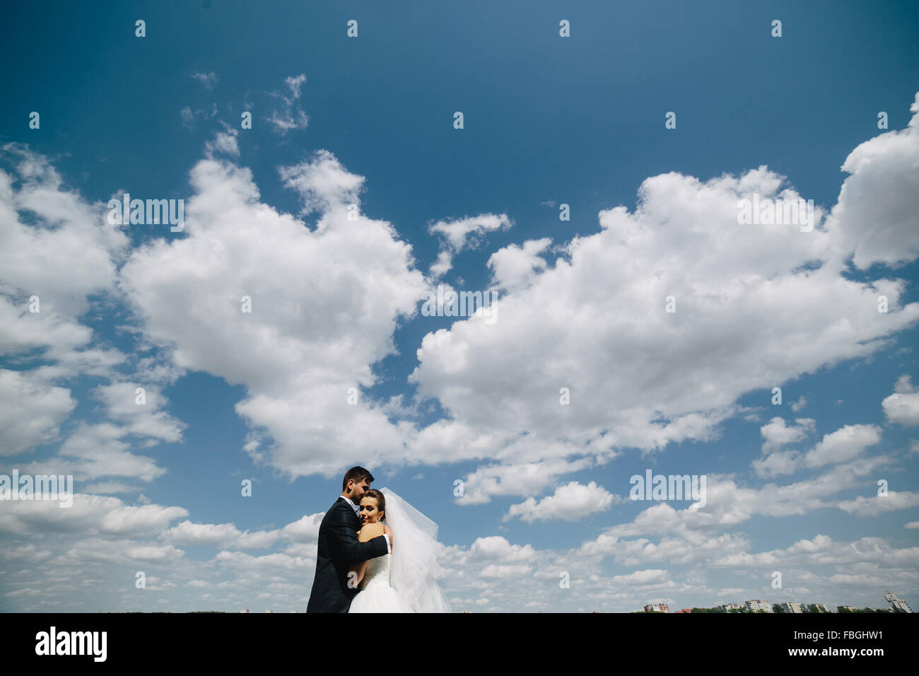 couple on blue sky background Stock Photo - Alamy