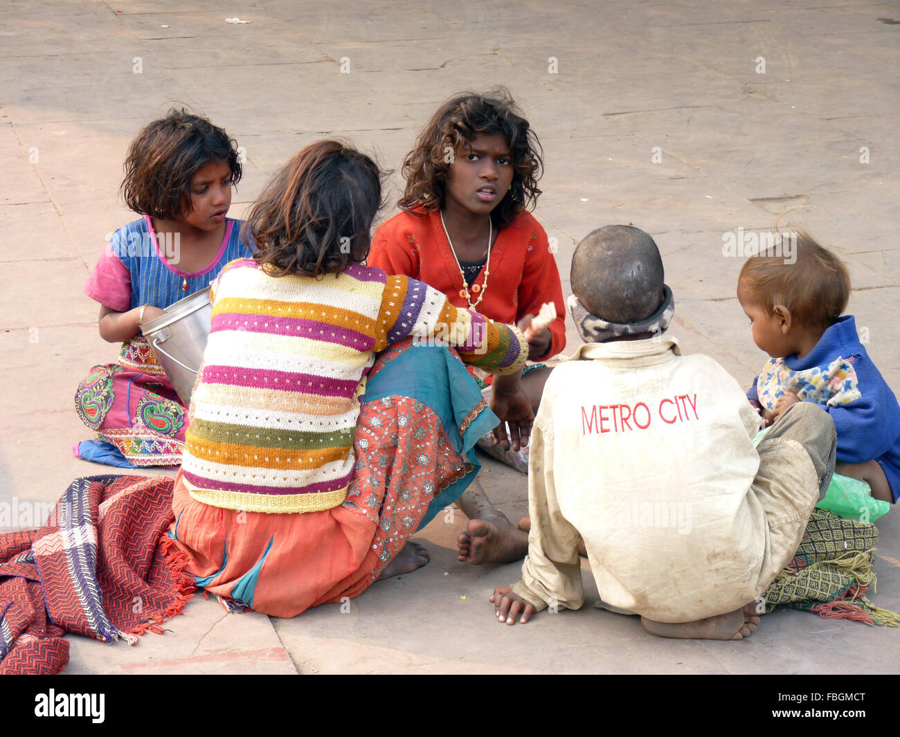 Group of Homeless Children Sitting on the Street in India Stock Photo