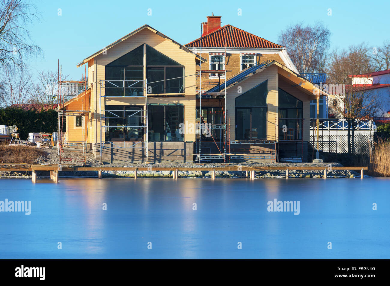 Karlskrona, Sweden - January 13, 2016: A home construction site with an almost finished house. People inside are working. Close Stock Photo