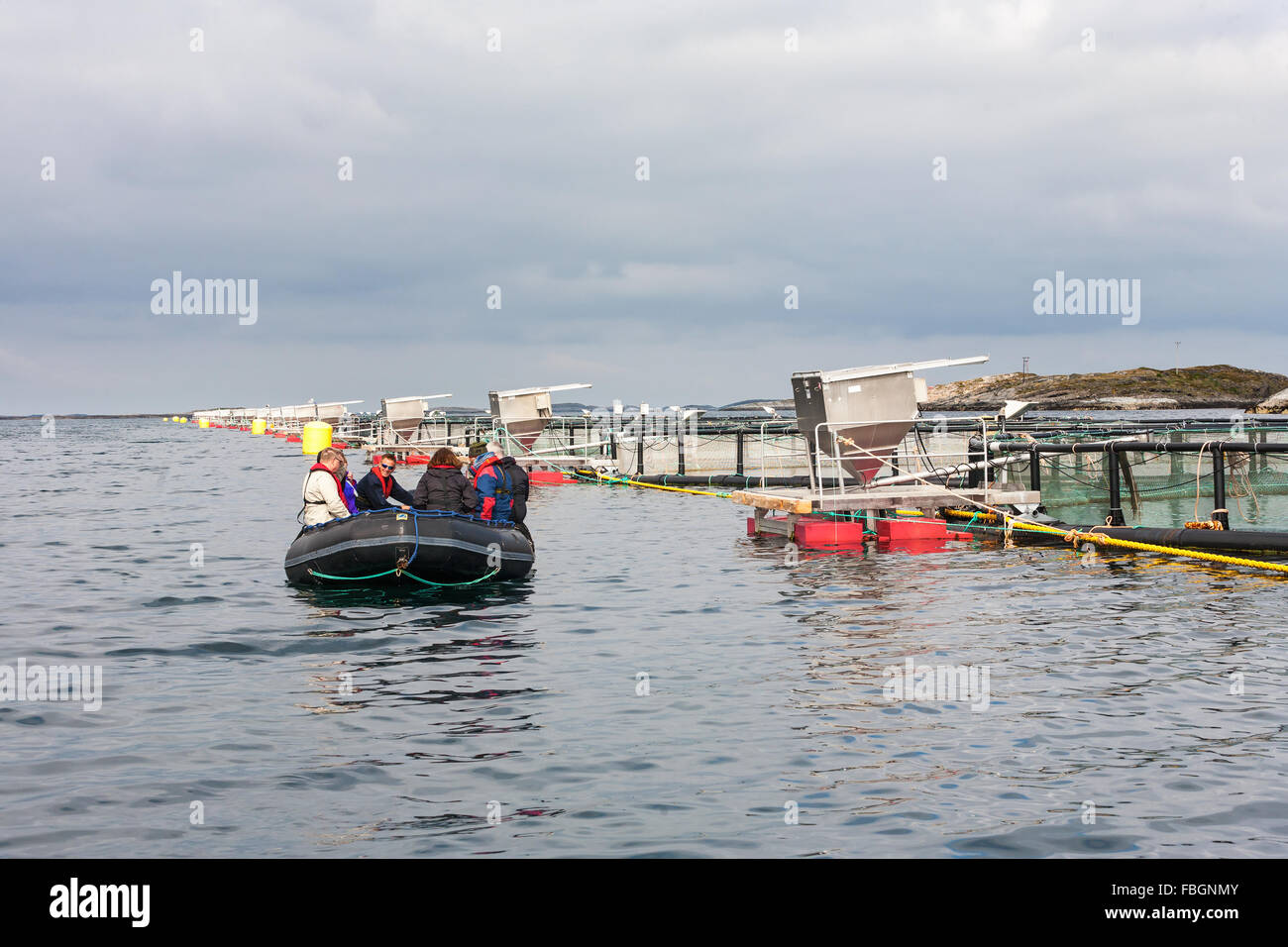 People in inflatable boat at a fish farming Stock Photo