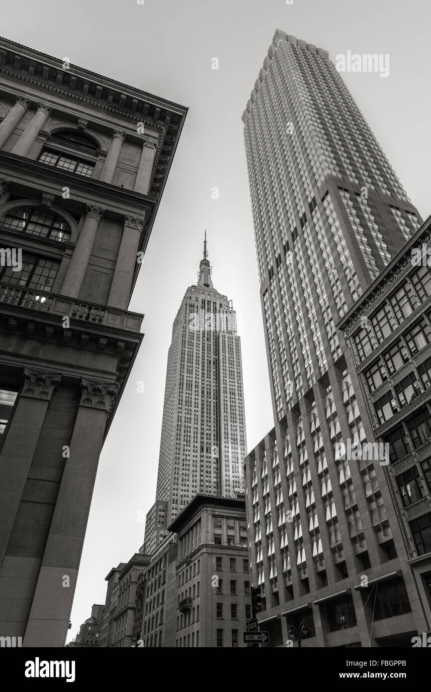 Black & White low angle view of the Art Deco style Empire State Building skyscraper from 5th Avenue, New York City Stock Photo