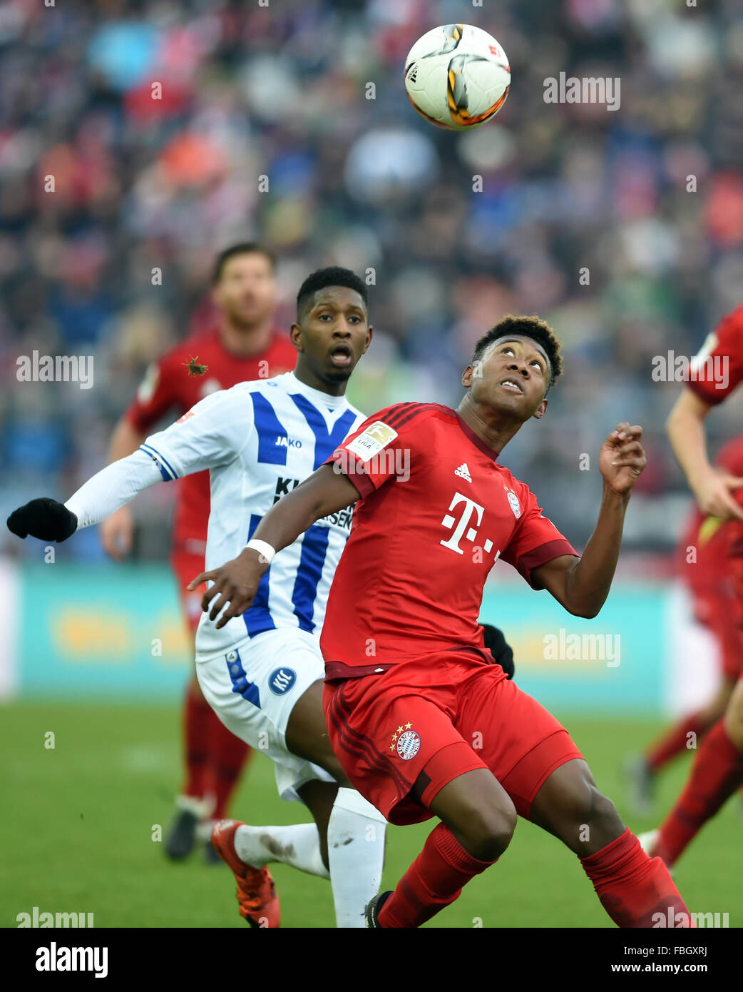 Karlsruhe, Germany. 16th Jan, 2016. Karlsruhe's Boubacar Barry (L) and Munich's David Alaba vie for the ball during the test match between Karlsruher SC and FC Bayern Munich in Wildpark Stadium in Karlsruhe, Germany, 16 January 2016. Munich's goalkeeper Manuel Neuer stands to the right. Photo: ULI DECK/dpa/Alamy Live News Stock Photo