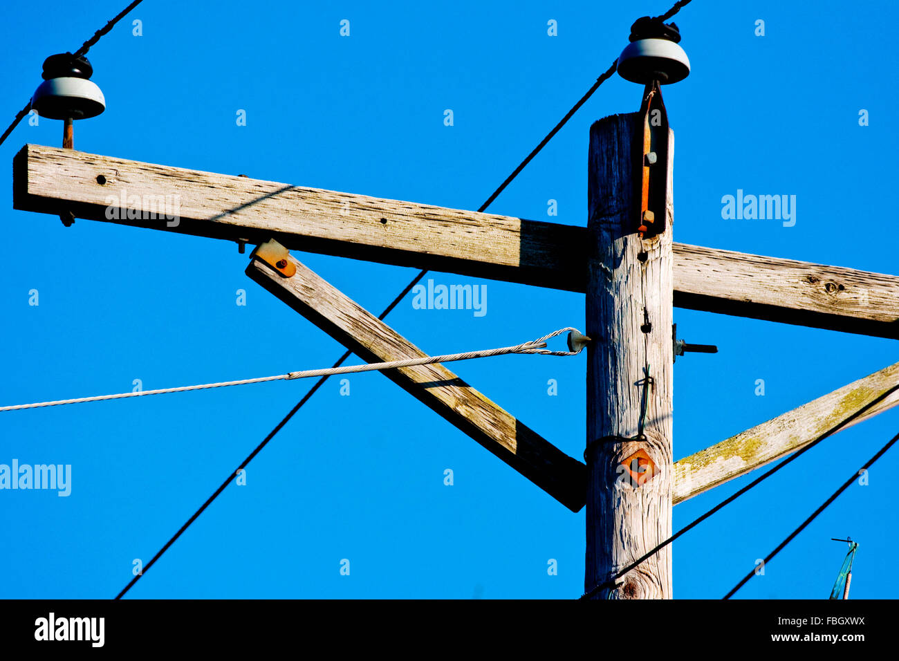 The top crossbar section of a telephone pole or power line post. Stock Photo