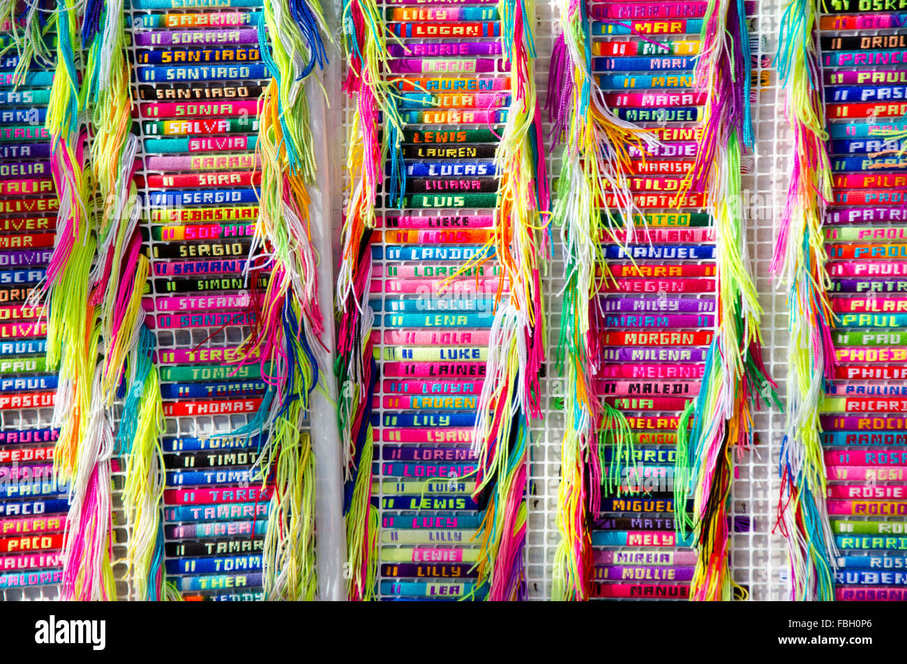 Woven braclets embroidered with names for sale in weekly market in Benidorm, Alicante, Spain Stock Photo