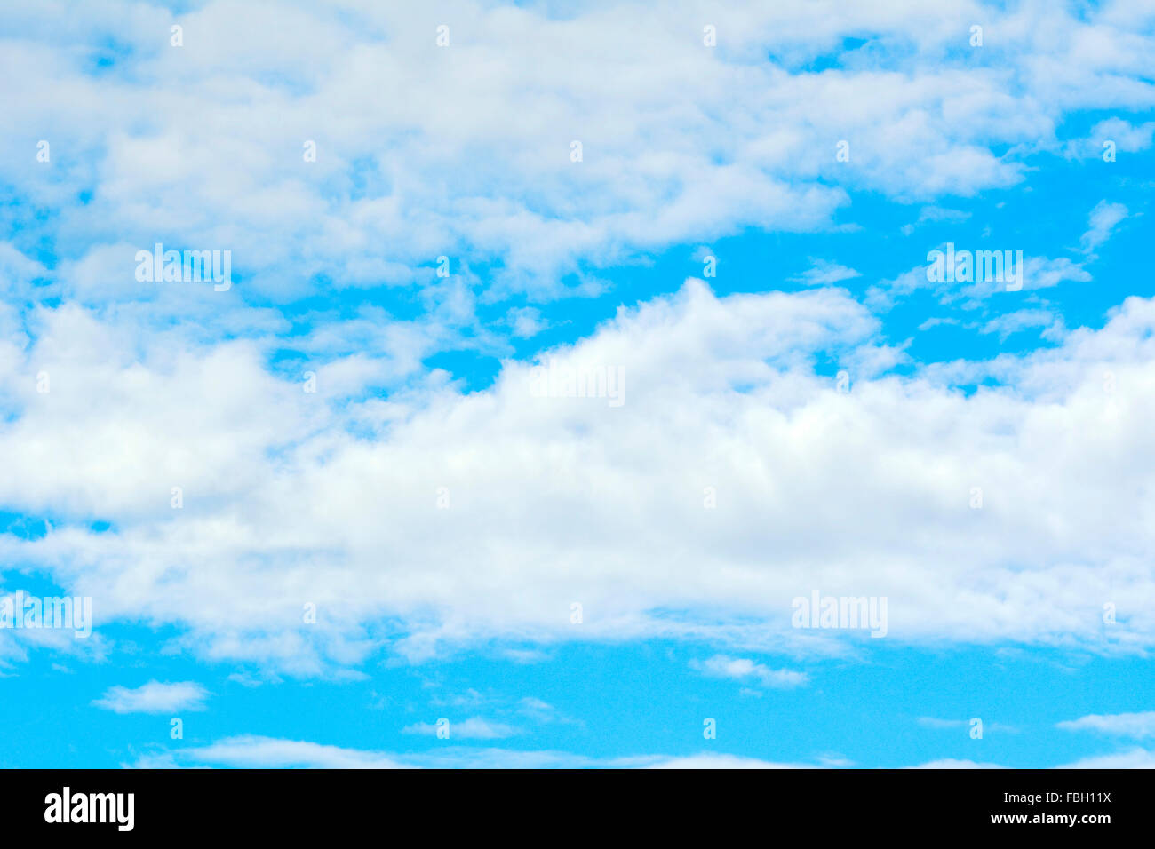 Puffy clouds in a blue sky. Stock Photo