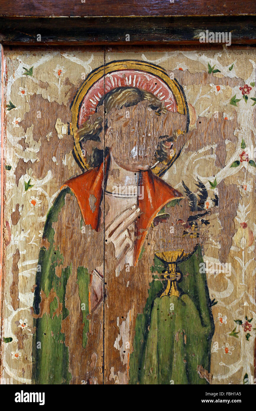 Painted Saint on the Rood Screen, defaced by iconoclasts: St John the Evangelist carrying the poisoned chalice, St Michael's Church, Irstead, Norfolk Stock Photo