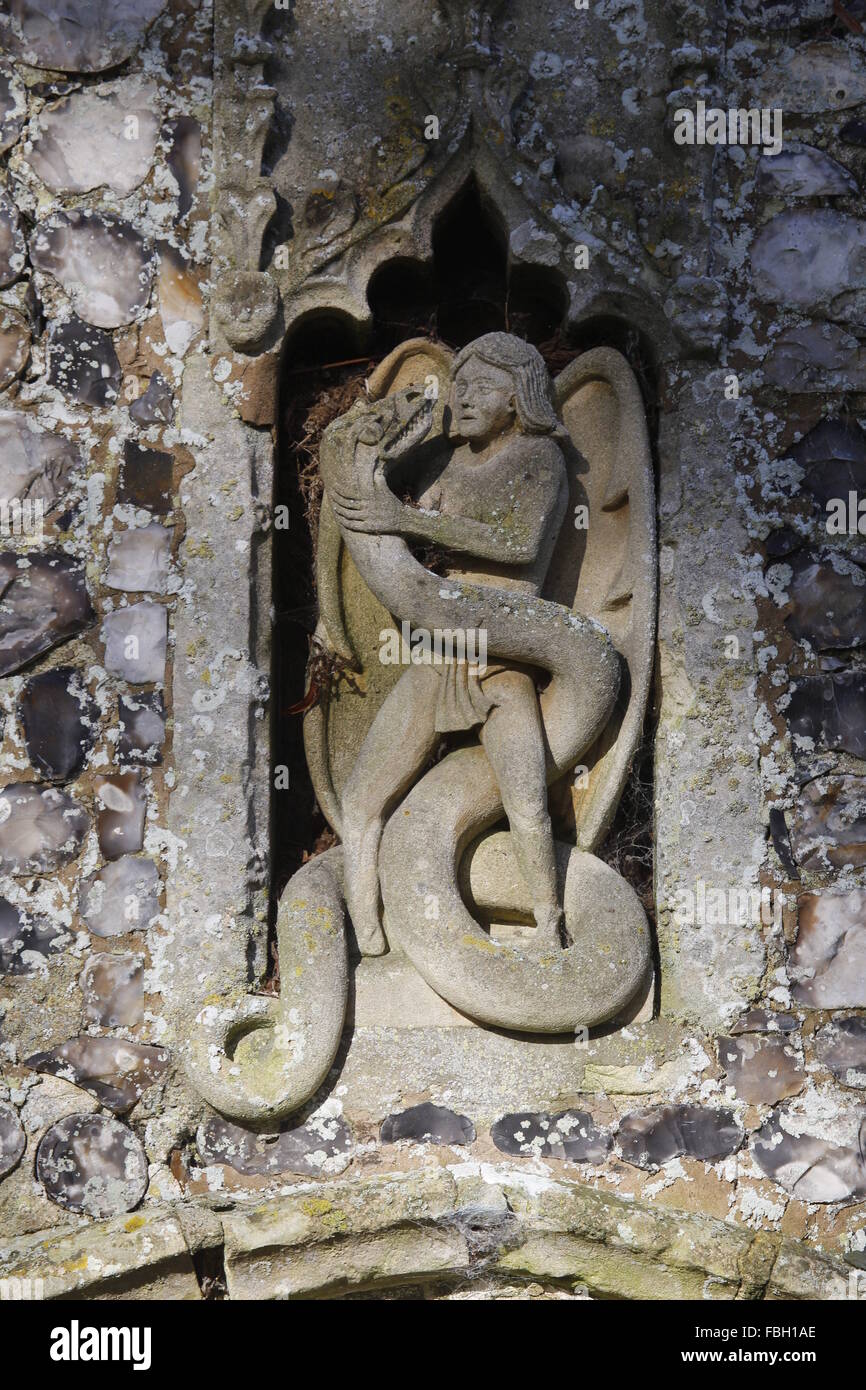 Carving of Archangel Michael fighting the serpent, St Michael's Church, Irstead, Norfolk Stock Photo