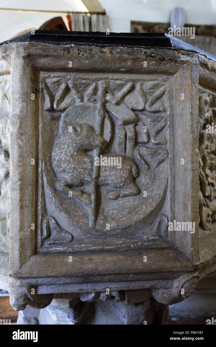14th century font. North face depicting the Lamb of God. St Michael's  Church, Irstead, Norfolk Stock Photo - Alamy