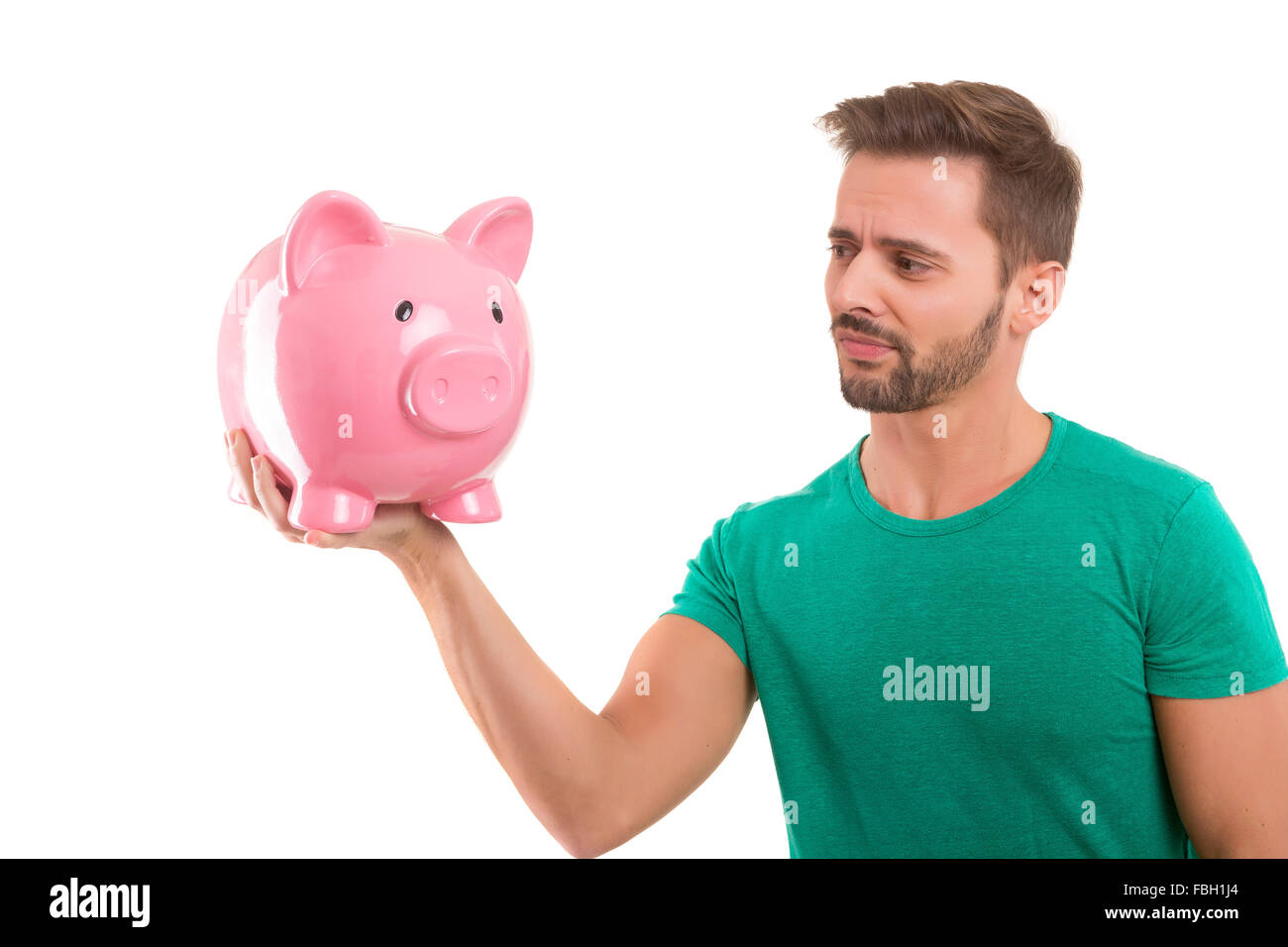 Young man holding a piggy-bank - money concept Stock Photo - Alamy