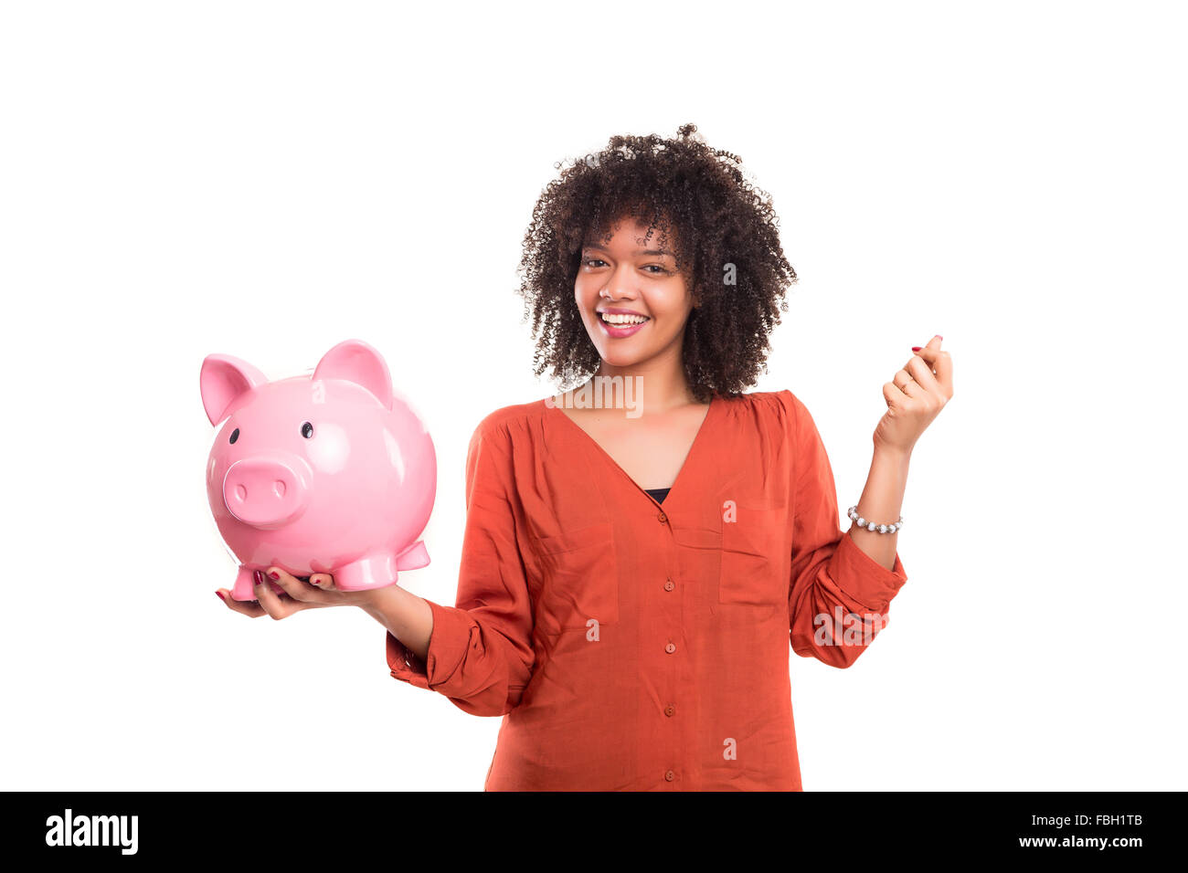 African woman putting some money into a piggy bank Stock Photo - Alamy