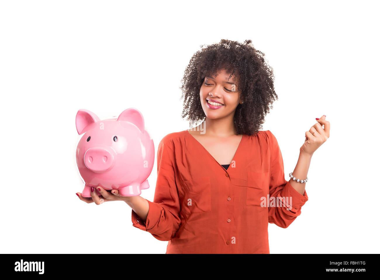 African woman putting some money into a piggy bank Stock Photo - Alamy