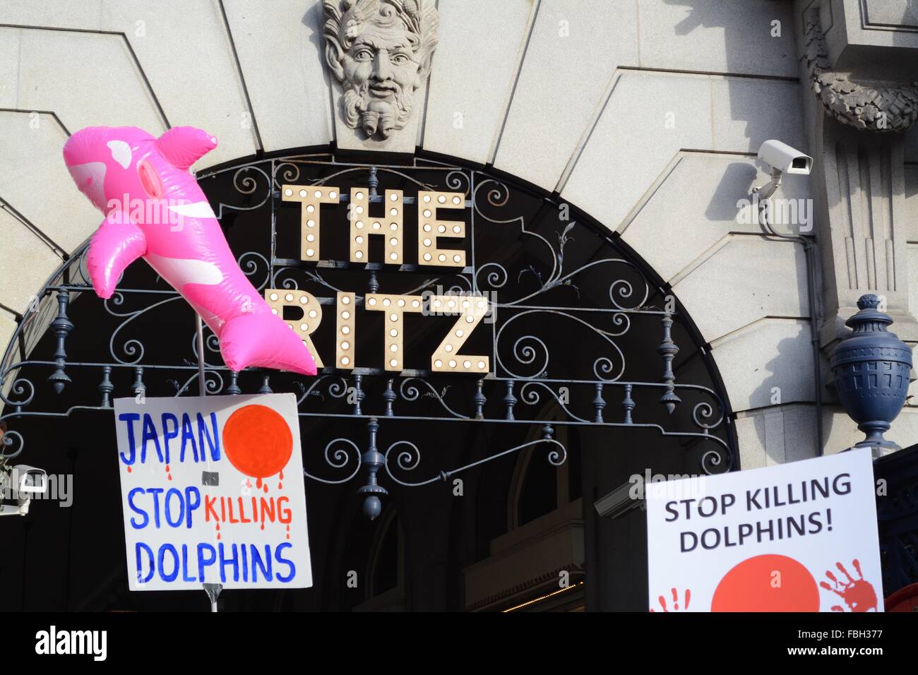 London, UK. 16th Jan, 2016. Inflatable Dolphin floats by the iconic Ritz sign as protesers march past. Credit:  Marc Ward/ Alamy Live News Stock Photo