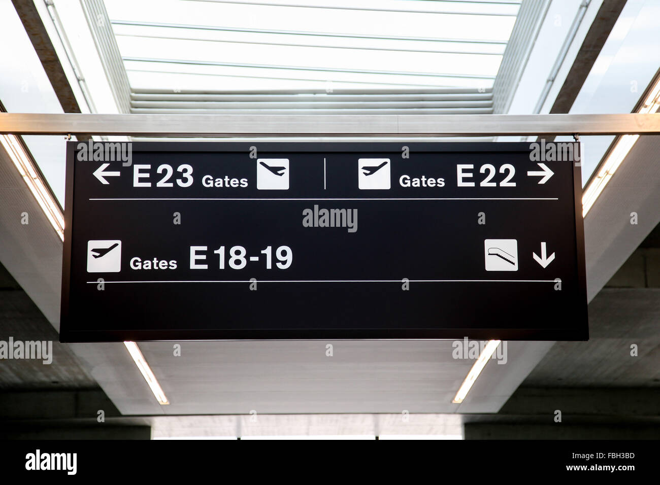 Zurich International Airport sign for departure gates and escalator