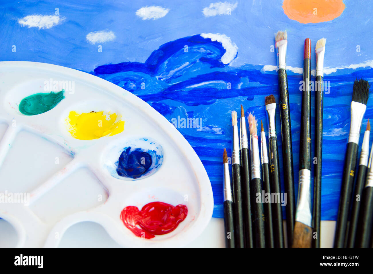 Paint brush and painters palette on table Stock Photo by ©seregam