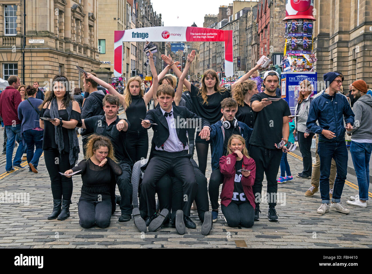 A group of performers promoting their show on the High Street during