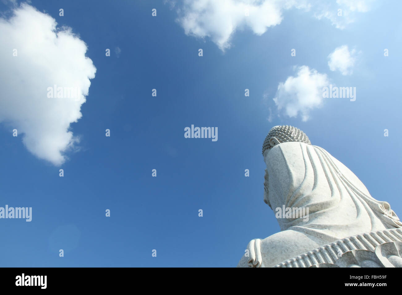 White buddha statue at blue sky background Stock Photo - Alamy