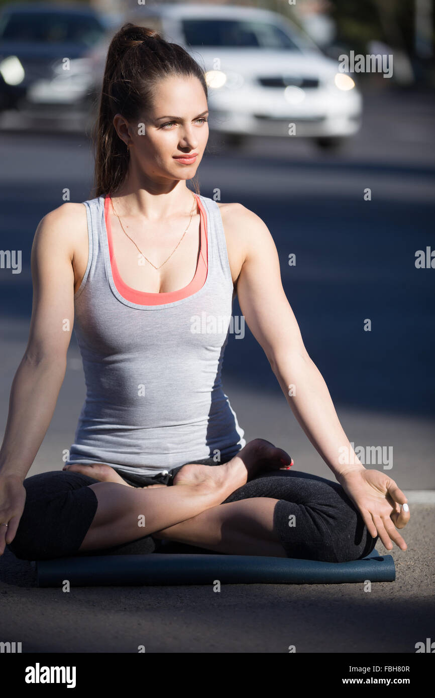 Yoga in the city: serene beautiful young fit woman wearing sportswear ...