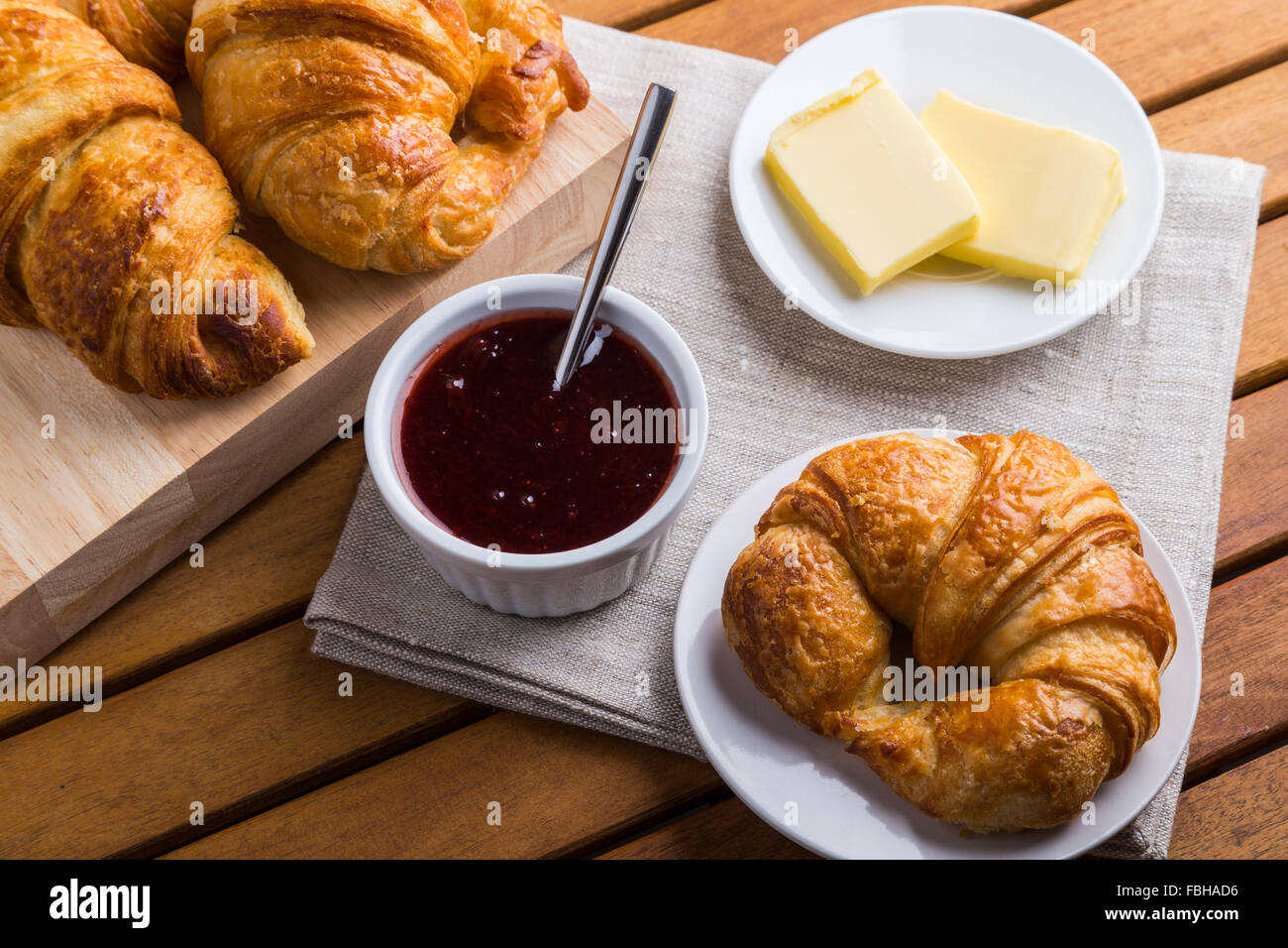 Croissants jam and butter on wooden table Stock Photo Alamy