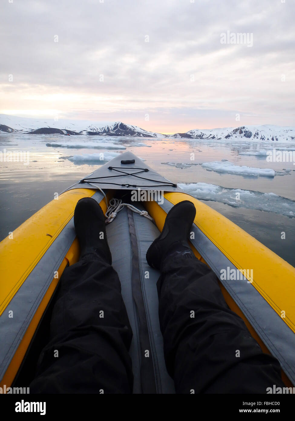 View inside kayak of sun setting over ice field in Antarctica. Stock Photo