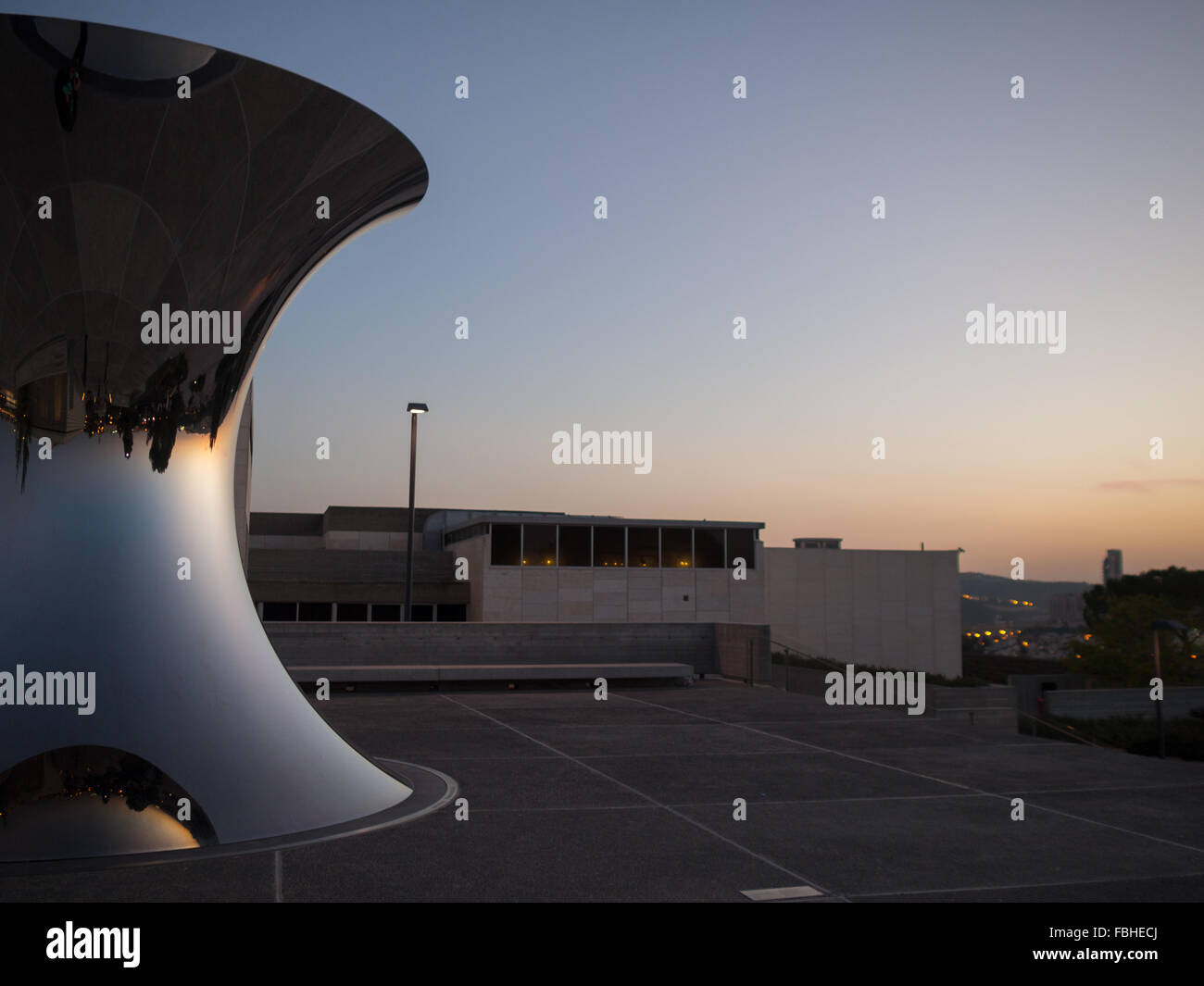 Sunset sky reflected in Anish Kapoor sculpture Turning the world upside down at Israel Museum Stock Photo