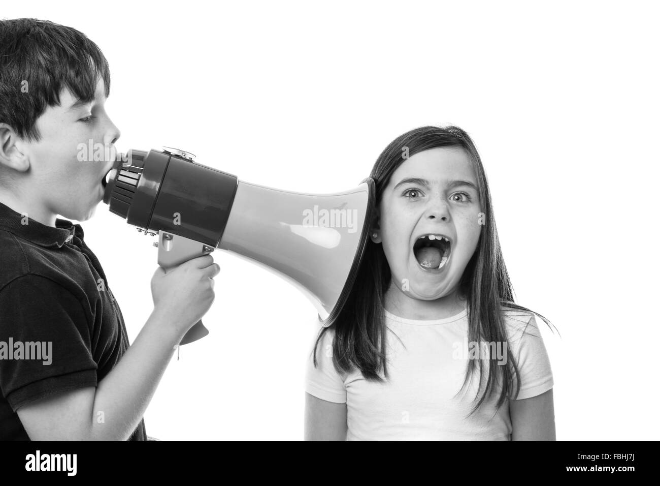 young boy using s megaphone to speak to his friend Stock Photo
