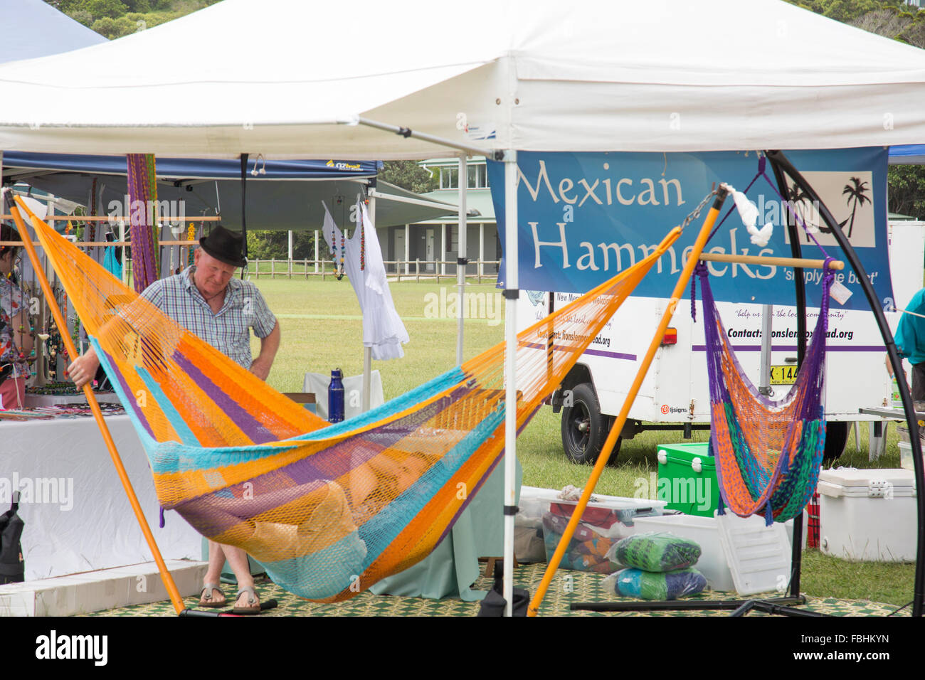 man tests a mexican hammock being sold at Lennox head sunday markets, new south wales,australia Stock Photo