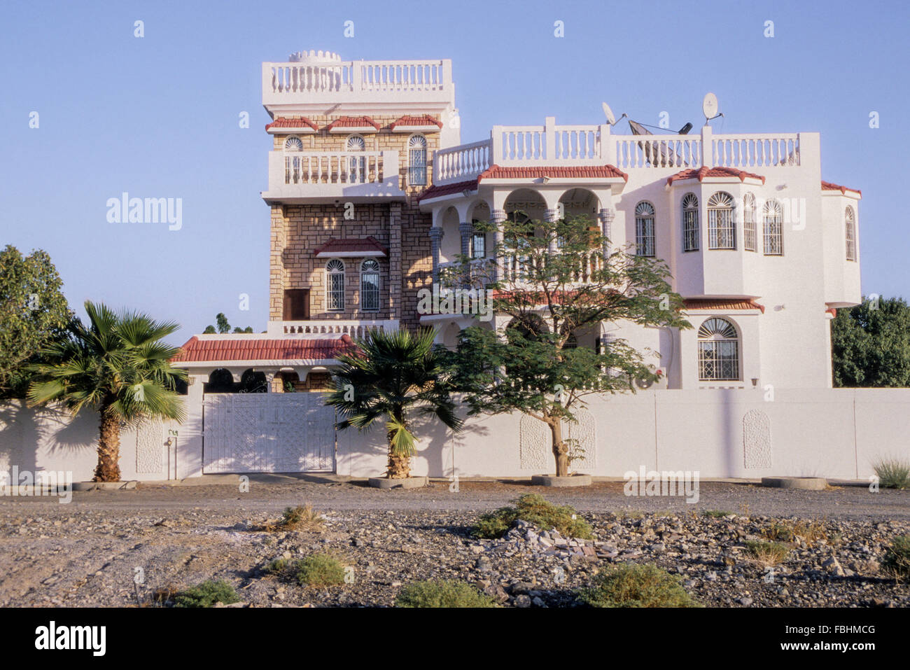 Bahla, Oman.  New Upper-middle-class House, with three satellite dishes. Stock Photo