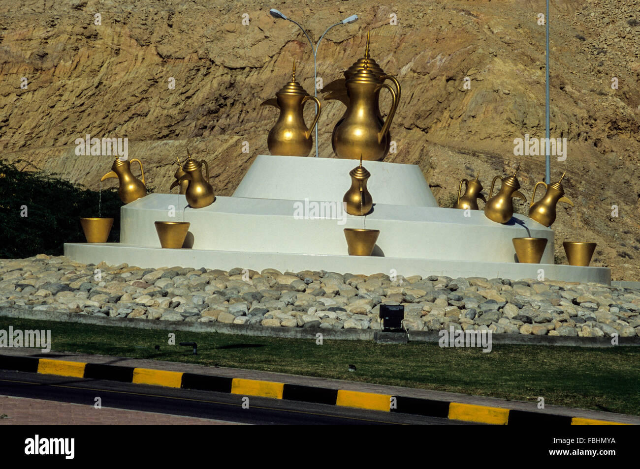 Between Ruwi and al-Bustan, Muscat Capital Area, Oman.  Public Art: Traditional Coffee Pots in a Traffic Roundabout. Stock Photo