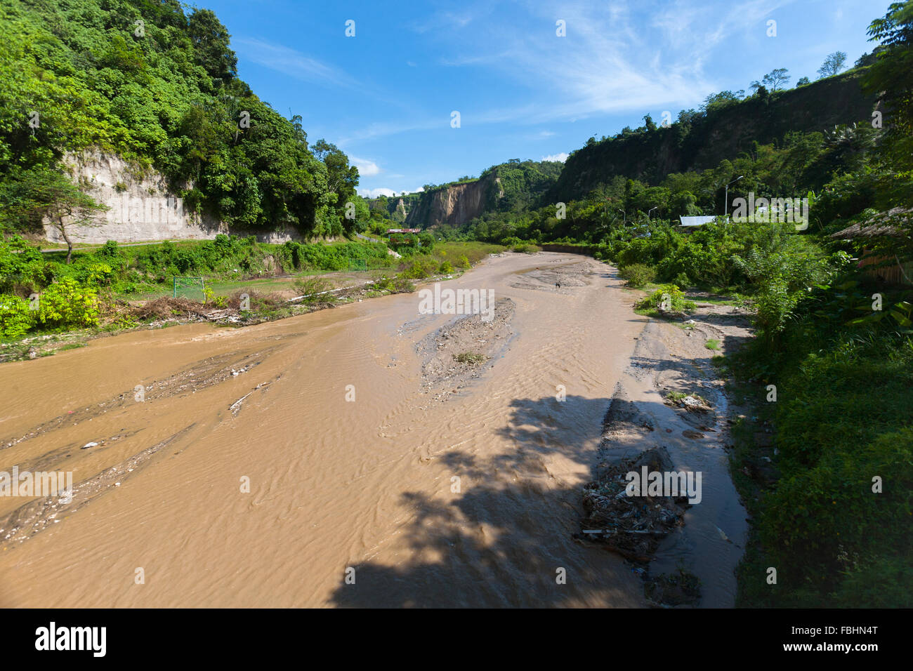 A muddy river in Ngarai Sianok (Sianok Canyon) in Bukittinggi, West Sumatra, Indonesia. Stock Photo