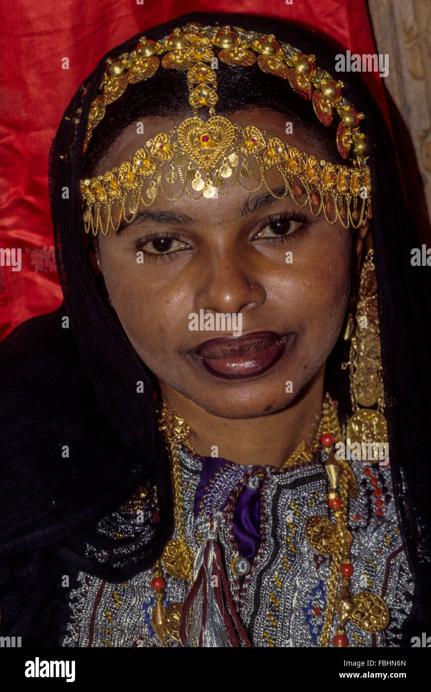 Oman.  Woman with Gold Jewelry Headdress and Necklace. Stock Photo