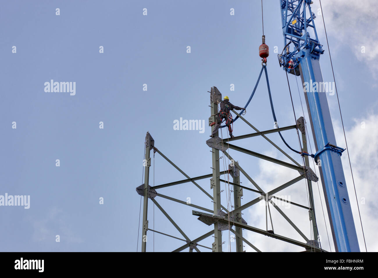 Assembling of the pylon, man workinging in the high-voltage power pylon, crane, Thuringian Forest Stock Photo