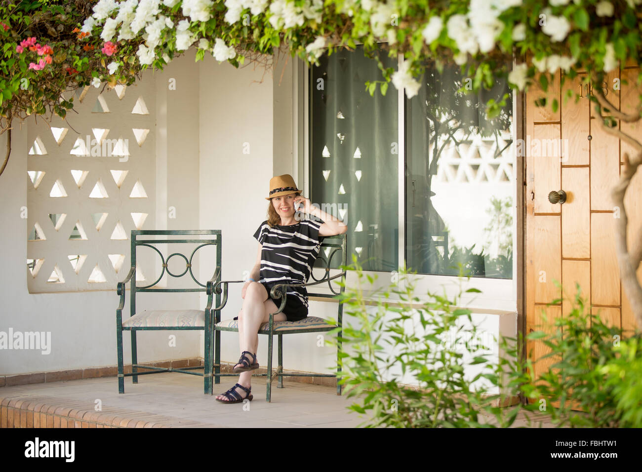 Woman sitting on porch veranda hi-res stock photography and images - Alamy