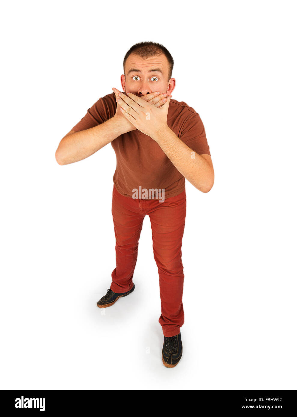 Young man closed his mouth with both hands isolated on white background Stock Photo