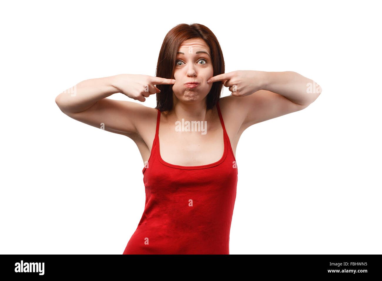 Young woman with puffed cheeks in a red shirt isolated on white background Stock Photo