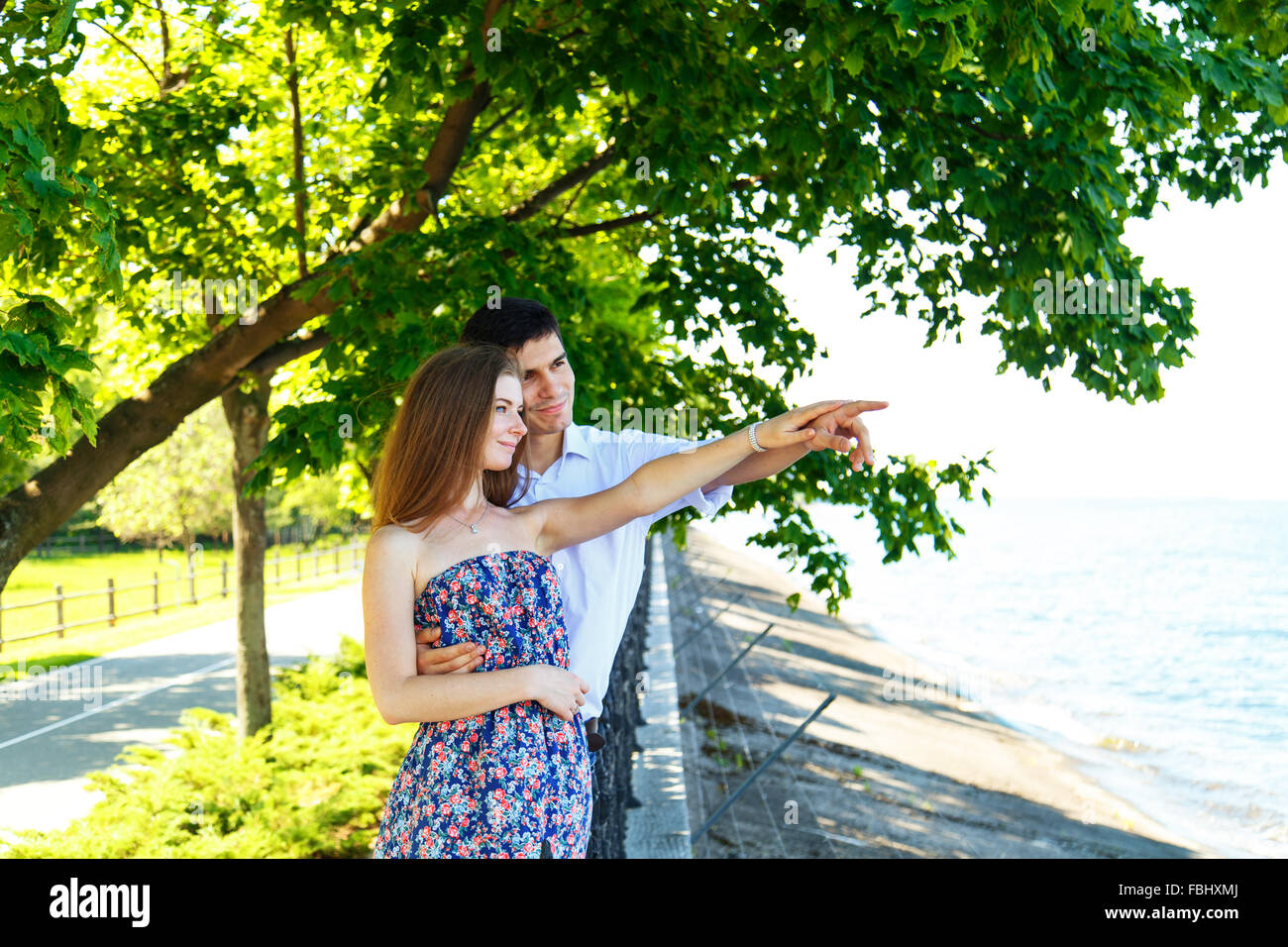 Lovers young man and woman walking in the summer park Stock Photo - Alamy