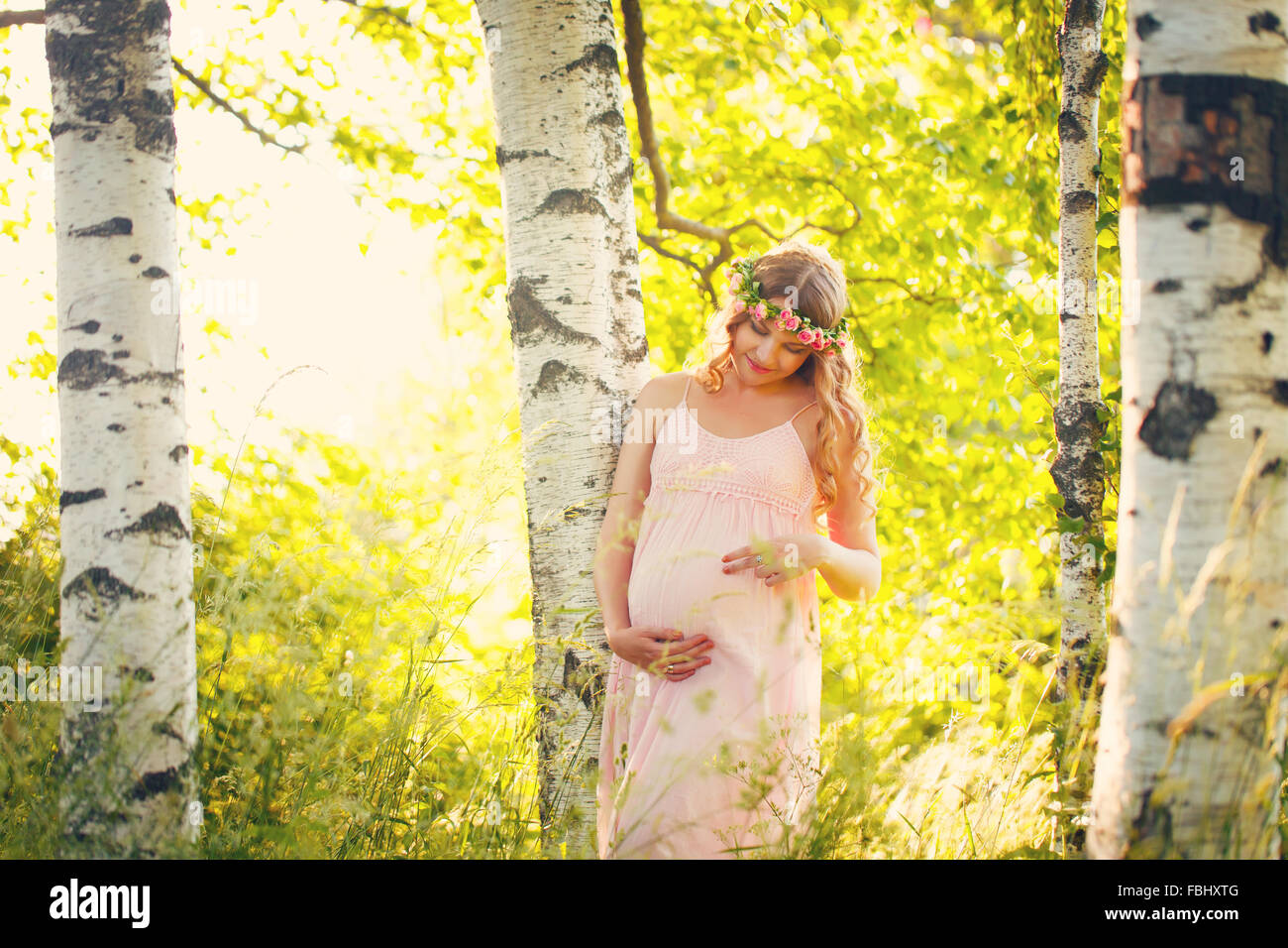 Beautiful pregnant woman relaxing outside in the park Stock Photo - Alamy