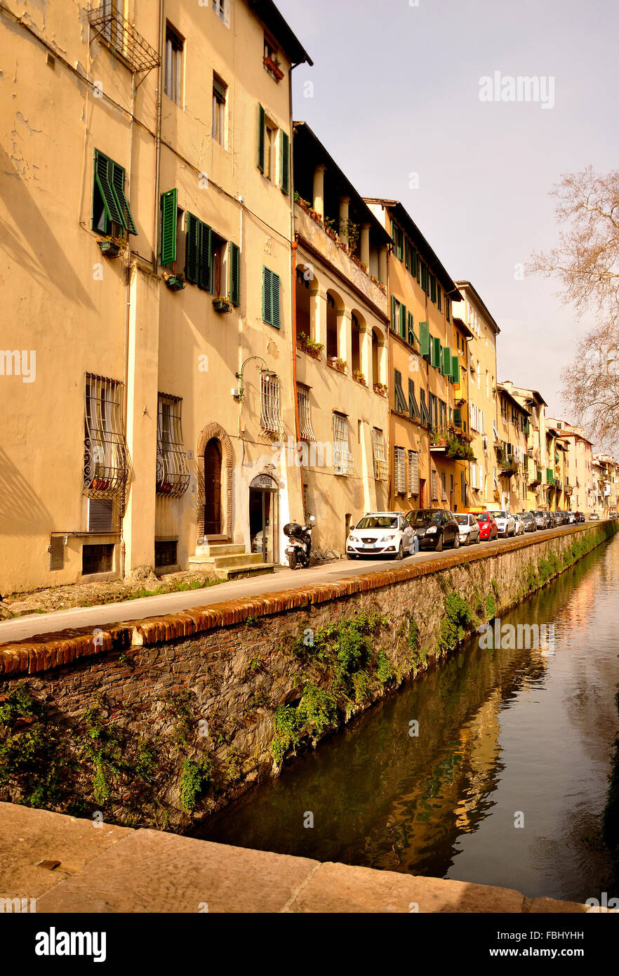 vertical view of Lucca's canal and medieval buildings which circle the old Renaissance town within Stock Photo