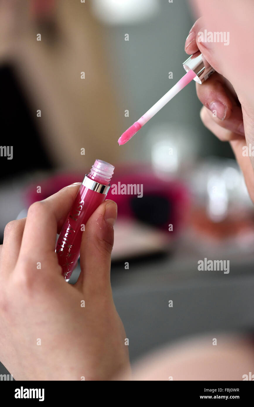 Lip gloss in girl's hands Stock Photo