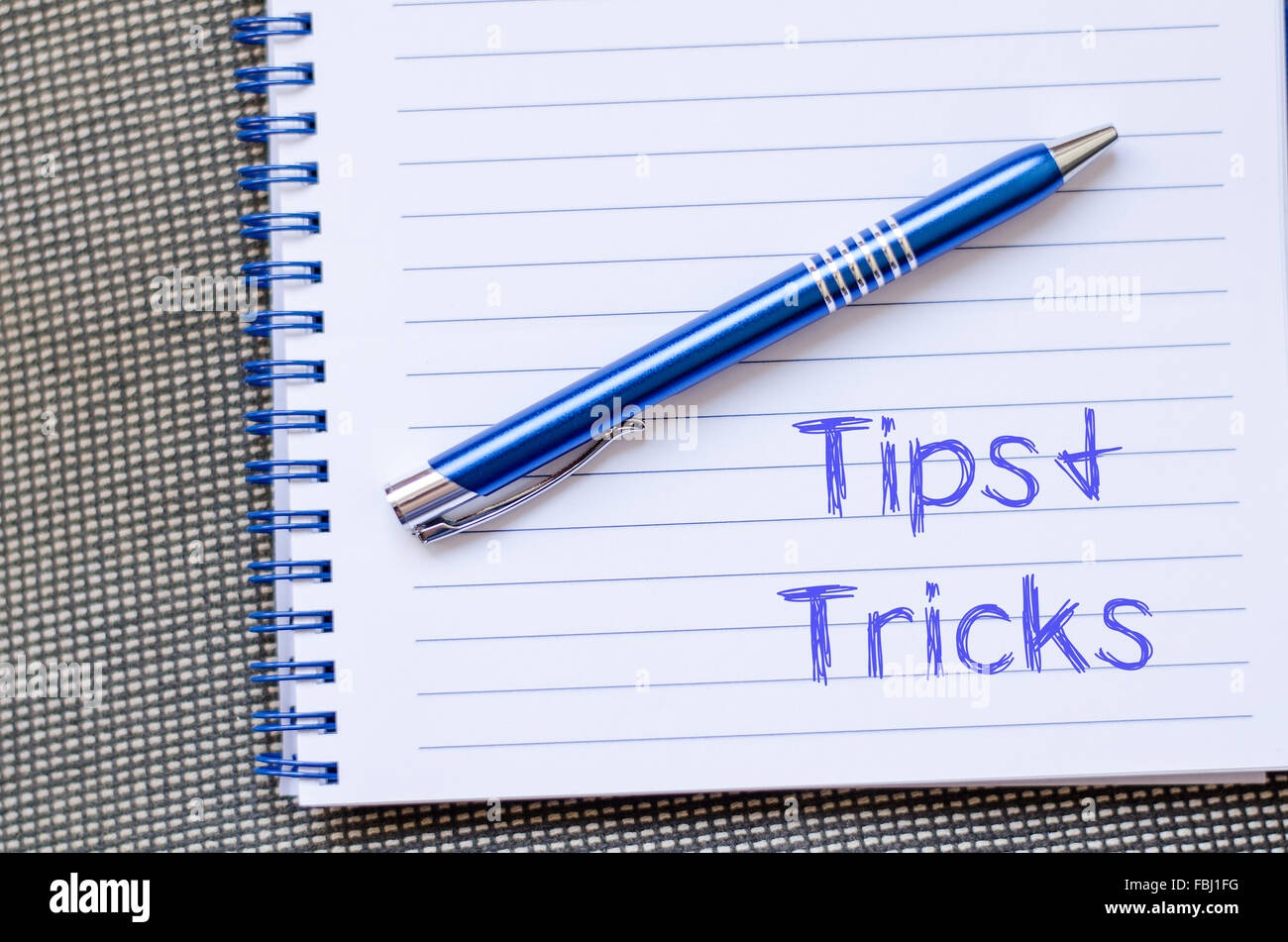 Tips and tricks text concept write on notebook with pen Stock Photo - Alamy